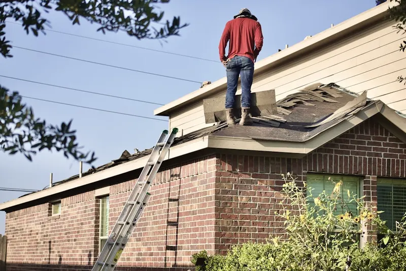 Professional roofer working on a residential roof in Fallbrook